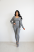 Two piece grey casual sweatsuit featuring a full zip-up hoodie and high-waisted leggings